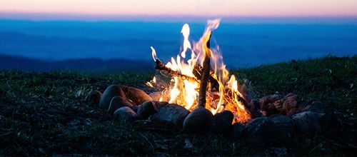Sitting together around a blazing fire - An ancient ritual that lives on today
